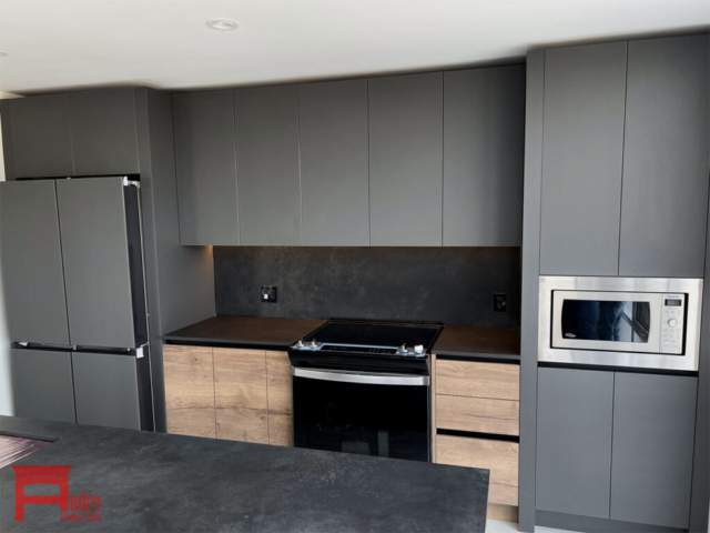 Modern Kitchen With Back Painted Glass Exterior, Handle Less Mechanism, Panel Ready Fridge, And Porcelain Countertop 2