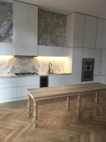 Modern Kitchen With Back Painted Acid Etched Glass Doors Marble Countertops And Backsplash Led Lighting And Maple Wood Center Island Table 1